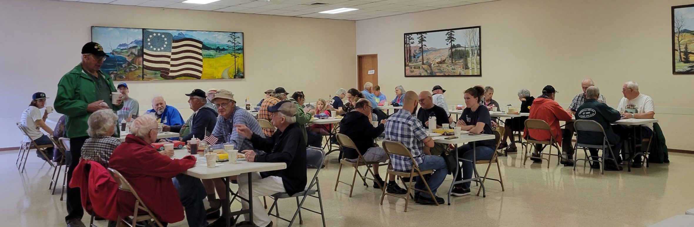 People at tables enjoying the Grange